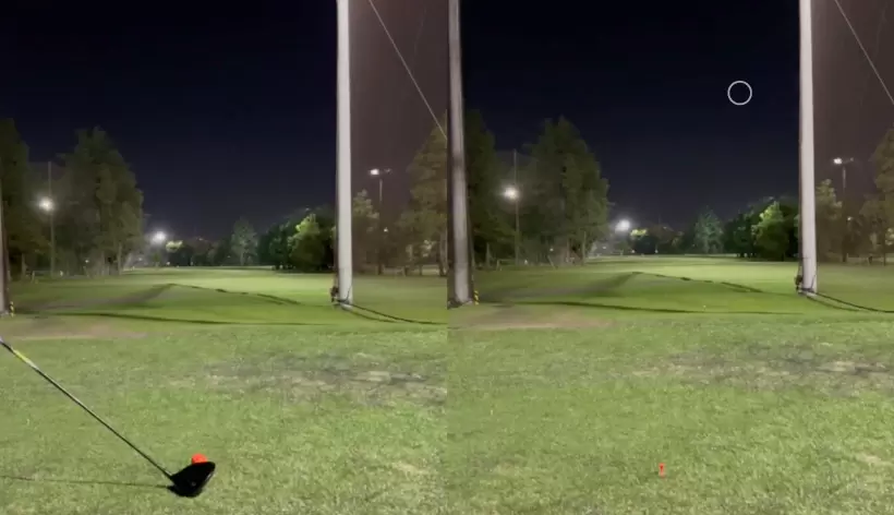 オレンジのゴルフボールをドライバーで打った写真