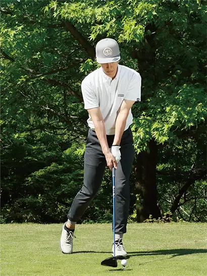 アドレスの姿勢から右足を大きく後ろに引いて構える。